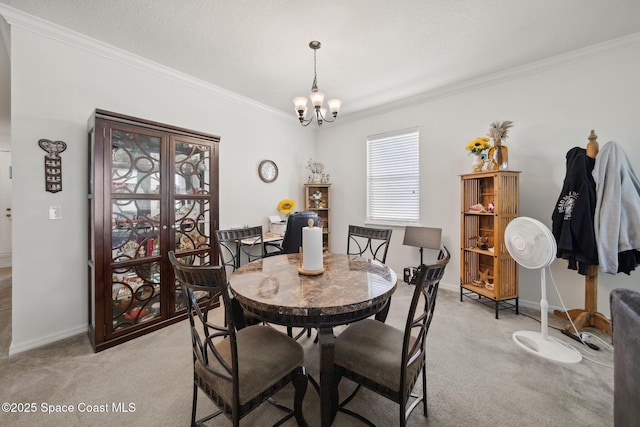 1662 Orsi Pl, West Melbourne, FL 32904 - dining room with light colored carpet, ornamental molding, a chandelier, and baseboards