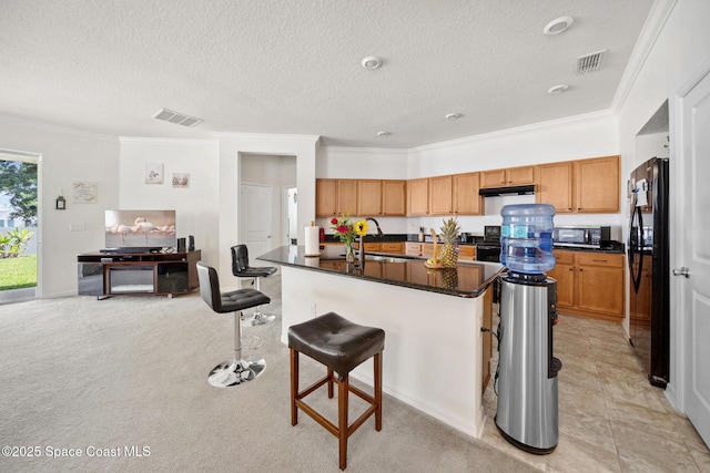 1662 Orsi Pl, West Melbourne, FL 32904 - kitchen featuring freestanding refrigerator, under cabinet range hood, a sink, ornamental molding, and dark countertops