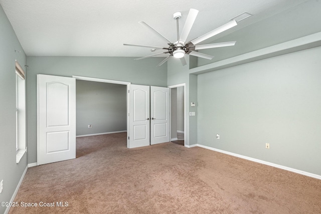 1536 Grand Isle Blvd, Melbourne, FL 32940 - unfurnished bedroom with carpet floors, baseboards, ceiling fan, and high vaulted ceiling