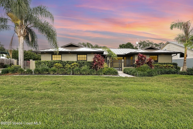 3204 Nottingham Ln, Cocoa, FL 32926 - ranch-style house with stucco siding, a standing seam roof, metal roof, and a gate