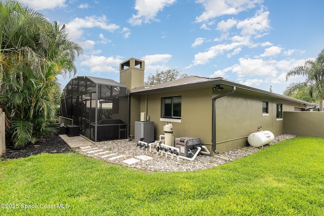 3204 Nottingham Ln, Cocoa, FL 32926 - rear view of house featuring stucco siding, a lawn, a lanai, and cooling unit