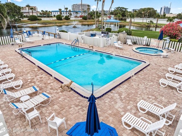 3165 N Atlantic Ave Unit C206, Cocoa Beach, FL 32931 - community pool with fence, a water view, a patio, and a hot tub