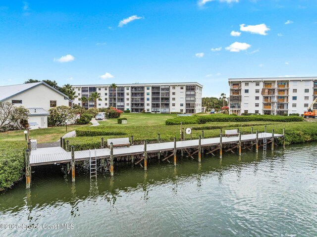 3165 N Atlantic Ave Unit C206, Cocoa Beach, FL 32931 - dock featuring a water view and a yard