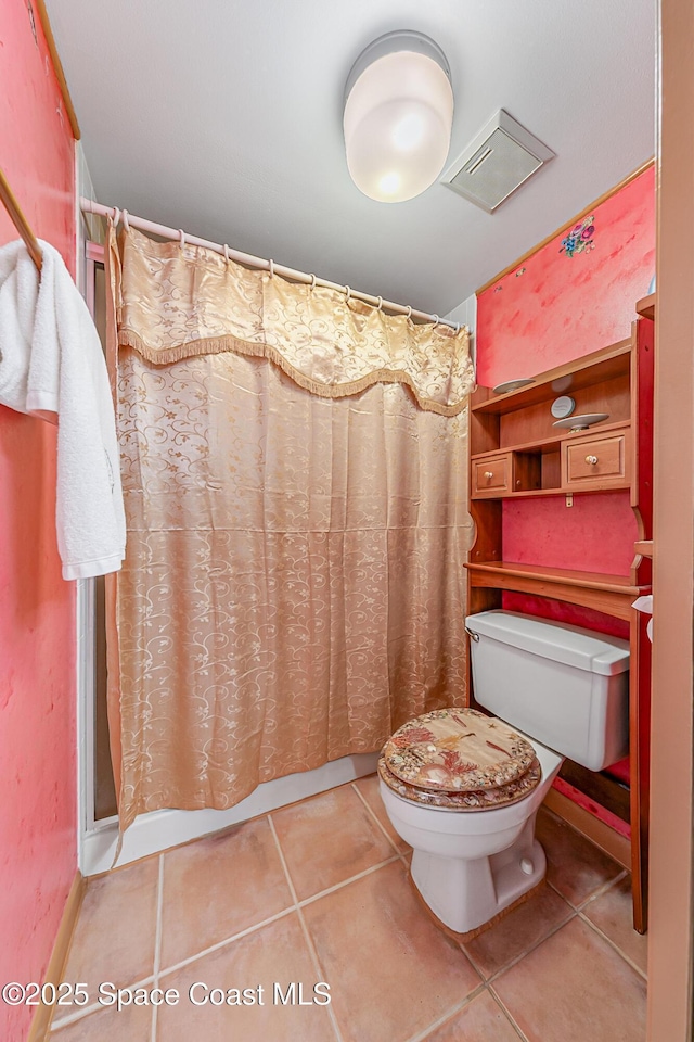 3165 N Atlantic Ave Unit C206, Cocoa Beach, FL 32931 - bathroom with tile patterned flooring, toilet, and a shower with curtain