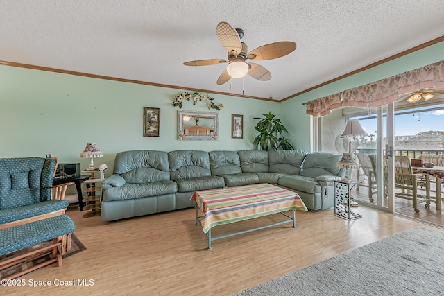 3165 N Atlantic Ave Unit C206, Cocoa Beach, FL 32931 - living room featuring ceiling fan, a textured ceiling, crown molding, and wood finished floors