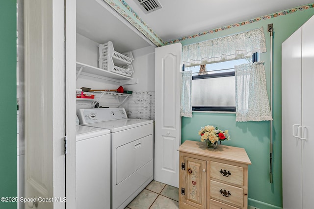 3165 N Atlantic Ave Unit C206, Cocoa Beach, FL 32931 - clothes washing area featuring washer and dryer and light tile patterned flooring