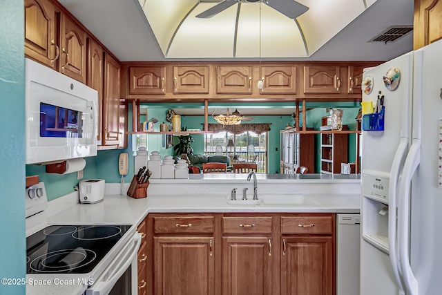 3165 N Atlantic Ave Unit C206, Cocoa Beach, FL 32931 - kitchen with white appliances, a sink, and brown cabinets