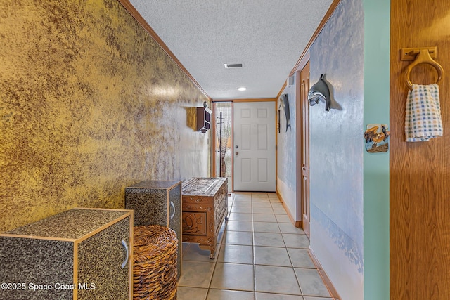 3165 N Atlantic Ave Unit C206, Cocoa Beach, FL 32931 - corridor with a textured ceiling, ornamental molding, and light tile patterned flooring
