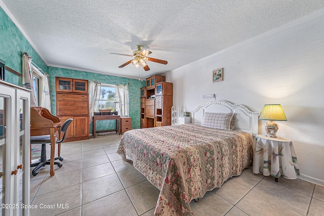 3165 N Atlantic Ave Unit C206, Cocoa Beach, FL 32931 - bedroom featuring light tile patterned flooring, a textured ceiling, a ceiling fan, and crown molding