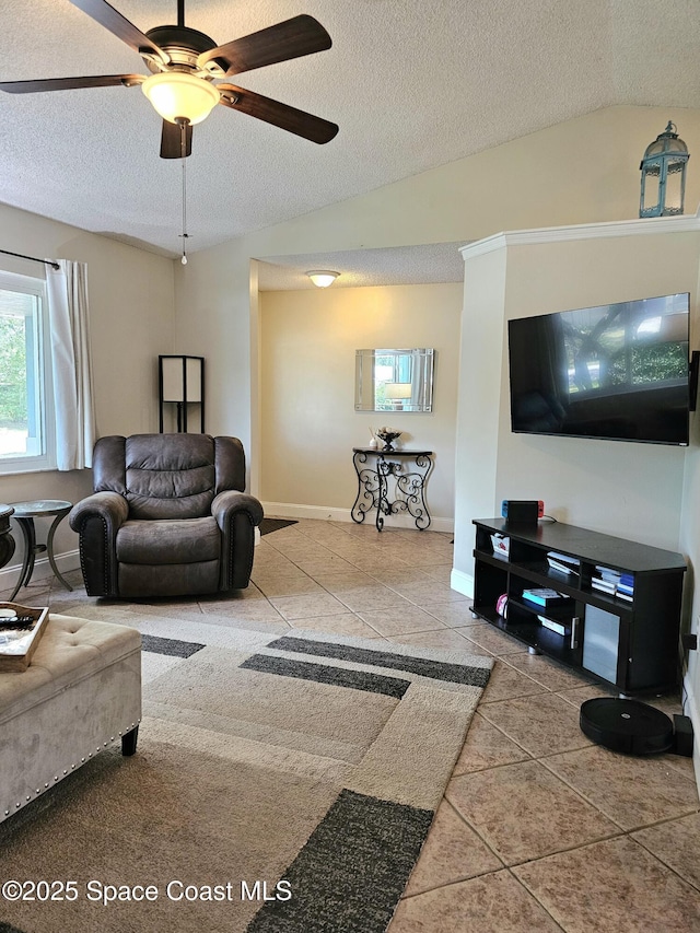 6630 Cecil Rd, Cocoa, FL 32927 - tiled living room with a textured ceiling, ceiling fan, and vaulted ceiling