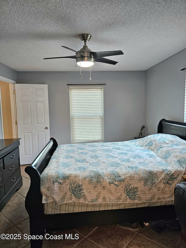 6630 Cecil Rd, Cocoa, FL 32927 - bedroom featuring a ceiling fan, tile patterned flooring, and a textured ceiling