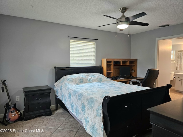 6630 Cecil Rd, Cocoa, FL 32927 - bedroom with a textured ceiling, a ceiling fan, a desk, connected bathroom, and light tile patterned floors