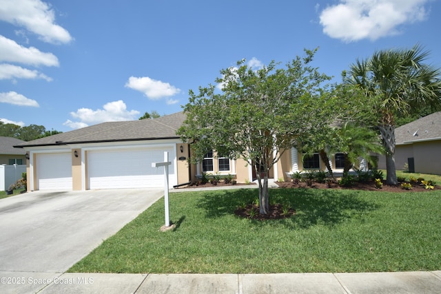 view of front of home with an attached garage, driveway, a front yard, and stucco siding