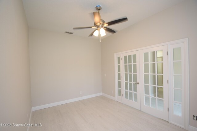 empty room featuring light wood-style flooring, a ceiling fan, and baseboards