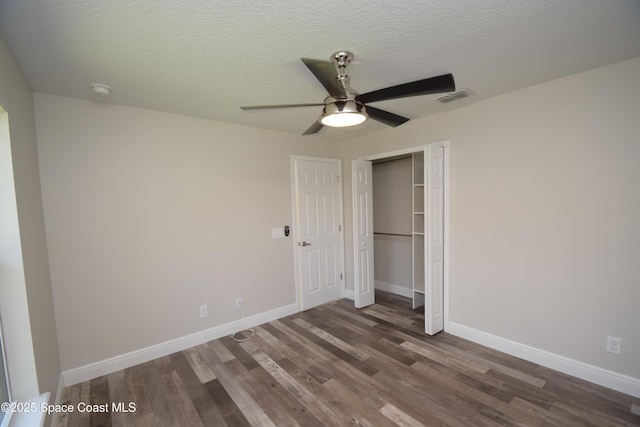 unfurnished bedroom featuring wood finished floors, baseboards, a closet, a textured ceiling, and a ceiling fan