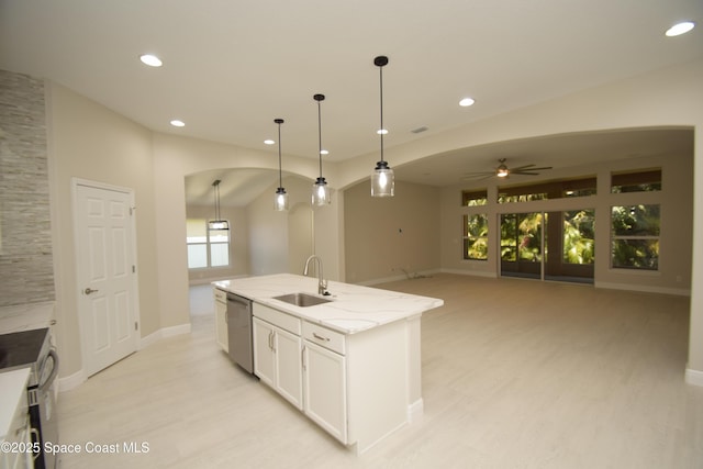 kitchen featuring a sink, stainless steel appliances, a ceiling fan, light wood-style flooring, and white cabinets