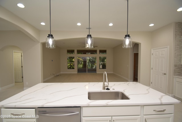 kitchen featuring a sink, recessed lighting, white cabinetry, a center island with sink, and open floor plan