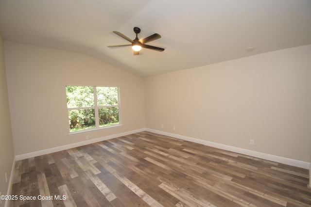 empty room with a ceiling fan, wood finished floors, vaulted ceiling, and baseboards