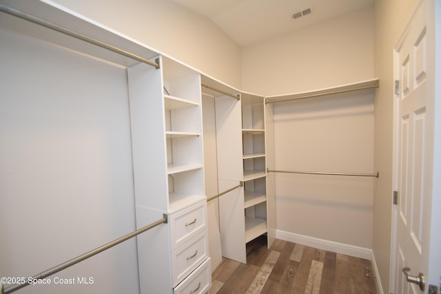 spacious closet with dark wood-type flooring