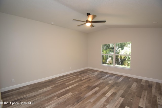 unfurnished room with a ceiling fan, baseboards, wood finished floors, and vaulted ceiling