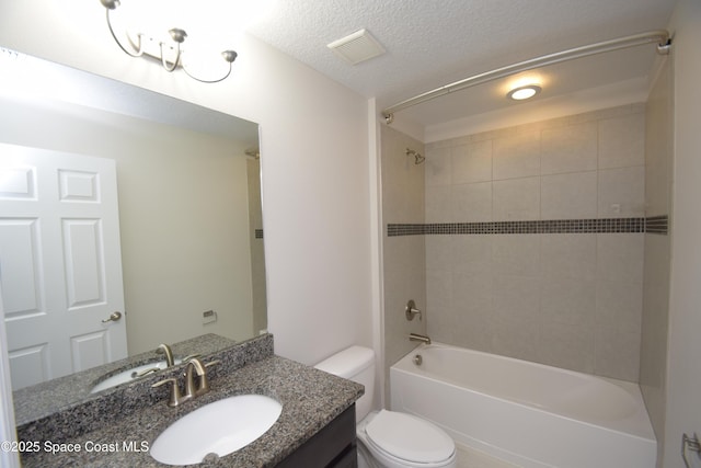 bathroom featuring toilet, vanity, and washtub / shower combination