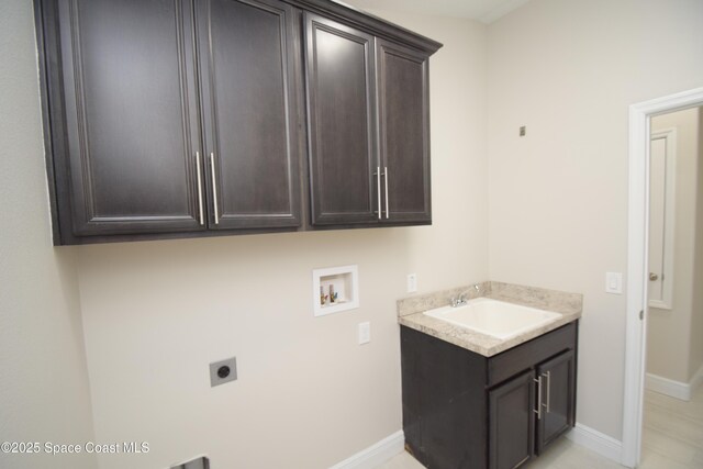laundry area featuring hookup for an electric dryer, hookup for a washing machine, cabinet space, and baseboards