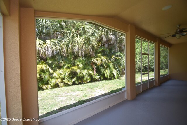 unfurnished sunroom featuring vaulted ceiling