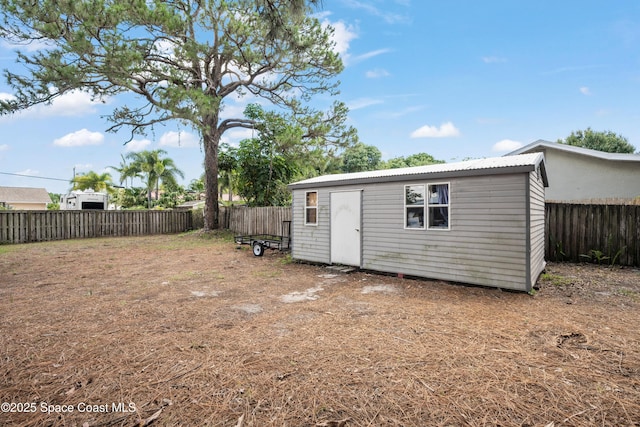 view of outdoor structure featuring a fenced backyard and an outdoor structure