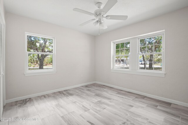 spare room featuring baseboards and a ceiling fan