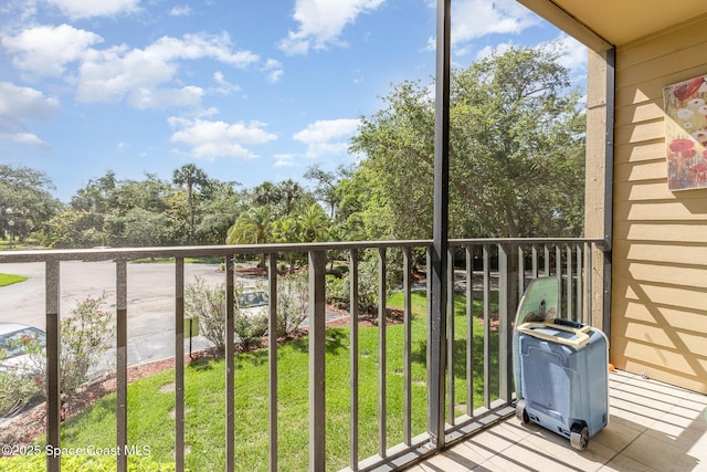 balcony featuring view of scattered trees
