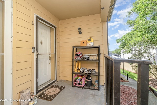 view of exterior entry with a balcony