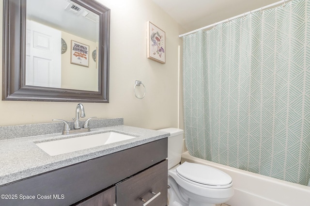 bathroom with vanity, toilet, and shower / bath combo
