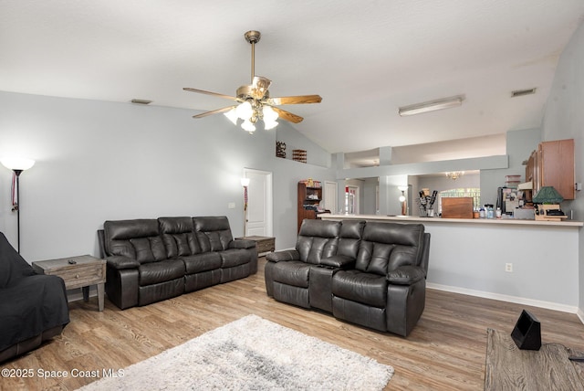 4465 Everglades St, Cocoa, FL 32927 - living room with lofted ceiling, light wood finished floors, ceiling fan, and baseboards