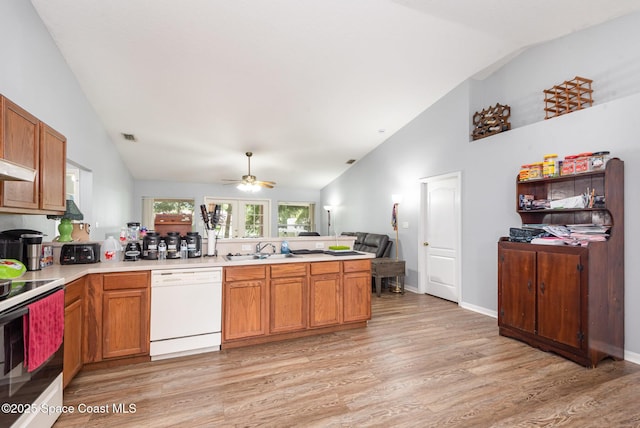 4465 Everglades St, Cocoa, FL 32927 - kitchen featuring white appliances, a sink, a peninsula, light wood-type flooring, and light countertops