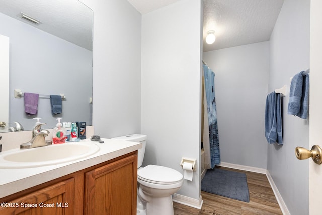 4465 Everglades St, Cocoa, FL 32927 - bathroom featuring toilet, wood finished floors, vanity, baseboards, and shower / tub combo