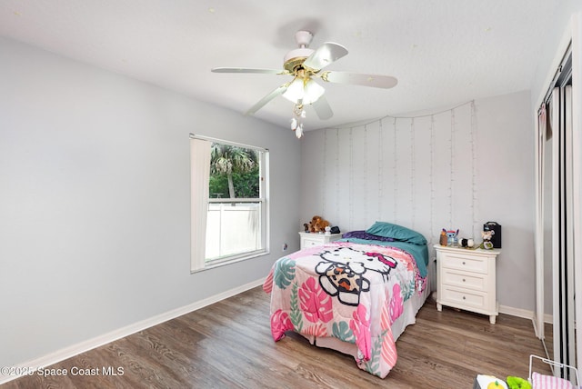 4465 Everglades St, Cocoa, FL 32927 - bedroom featuring wood finished floors, a closet, baseboards, and a ceiling fan