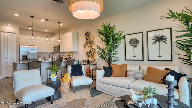 1272 Miraflores Trl NW, Palm Bay, FL 32907 - living area featuring wood finished floors and recessed lighting