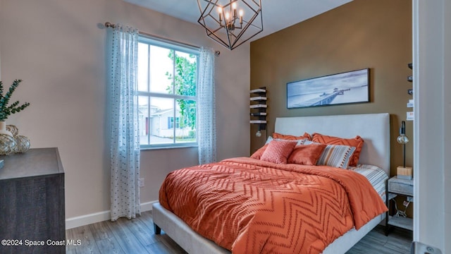 1272 Miraflores Trl NW, Palm Bay, FL 32907 - bedroom featuring wood finished floors, a chandelier, and baseboards
