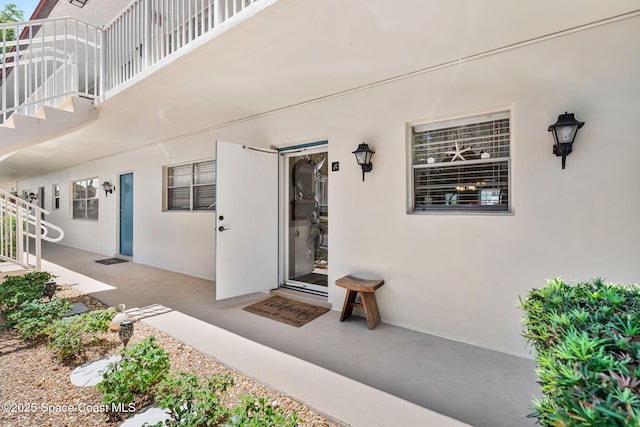 261 Cape Shores Cir Unit 18-E, Cape Canaveral, FL 32920 - doorway to property featuring stucco siding