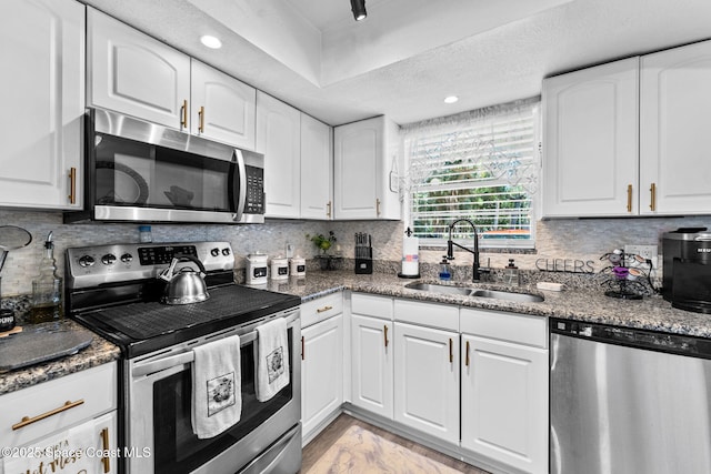 261 Cape Shores Cir Unit 18-E, Cape Canaveral, FL 32920 - kitchen featuring stainless steel appliances, a sink, white cabinetry, backsplash, and recessed lighting