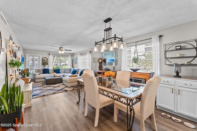 261 Cape Shores Cir Unit 18-E, Cape Canaveral, FL 32920 - dining space with light wood finished floors, a textured ceiling, and ceiling fan