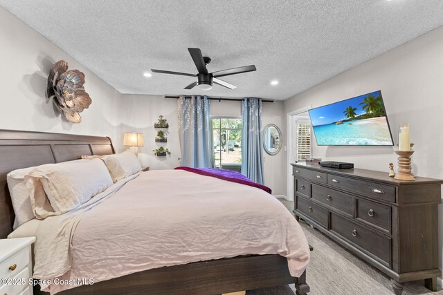 261 Cape Shores Cir Unit 18-E, Cape Canaveral, FL 32920 - bedroom featuring light carpet, a textured ceiling, ceiling fan, and recessed lighting