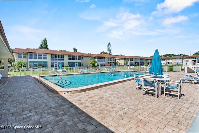 261 Cape Shores Cir Unit 18-E, Cape Canaveral, FL 32920 - community pool featuring a patio and fence