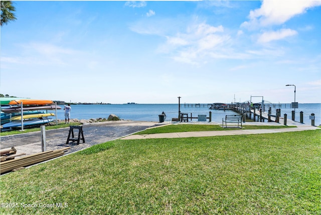 261 Cape Shores Cir Unit 18-E, Cape Canaveral, FL 32920 - dock with a yard and a water view