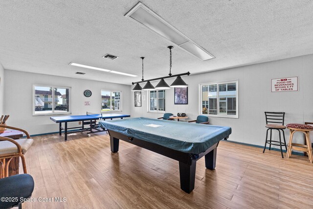 261 Cape Shores Cir Unit 18-E, Cape Canaveral, FL 32920 - recreation room featuring a textured ceiling, billiards, wood finished floors, and baseboards