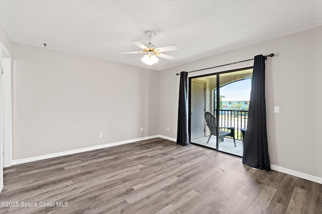 7201 Ridgewood Ave Unit 23, Cape Canaveral, FL 32920 - unfurnished room with wood finished floors, a ceiling fan, a textured ceiling, and baseboards