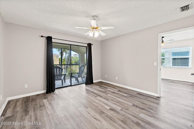 7201 Ridgewood Ave Unit 23, Cape Canaveral, FL 32920 - spare room with ceiling fan, wood finished floors, a textured ceiling, and baseboards