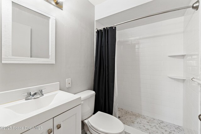7201 Ridgewood Ave Unit 23, Cape Canaveral, FL 32920 - bathroom featuring toilet, a tile shower, and vanity