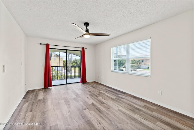 7201 Ridgewood Ave Unit 23, Cape Canaveral, FL 32920 - empty room featuring a textured ceiling, wood finished floors, ceiling fan, and baseboards