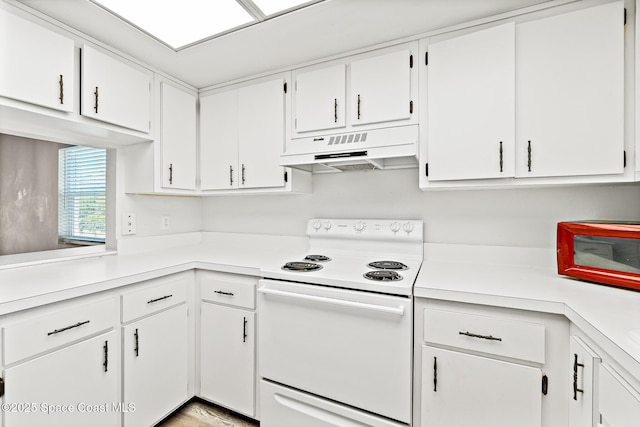 7201 Ridgewood Ave Unit 23, Cape Canaveral, FL 32920 - kitchen featuring under cabinet range hood, white electric range oven, light countertops, and white cabinetry